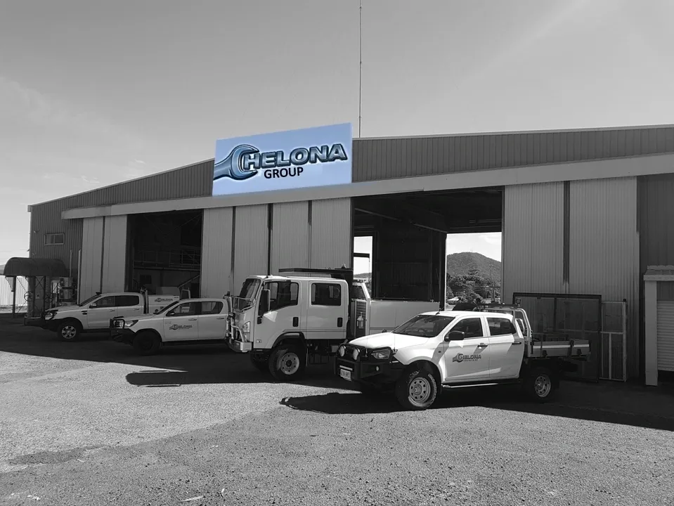 Chelona Group workshop exterior with company vehicles parked outside